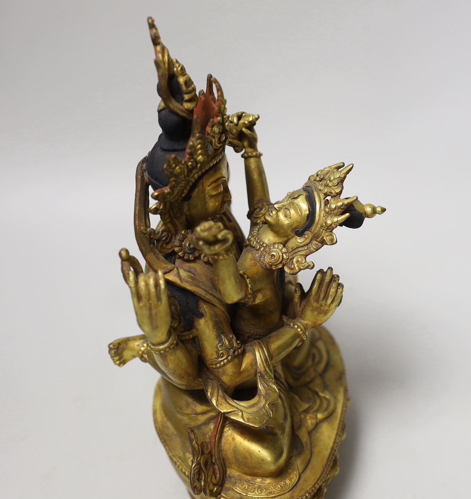 A Sino-Tibetan gilt bronze Buddha and consort, 23cm